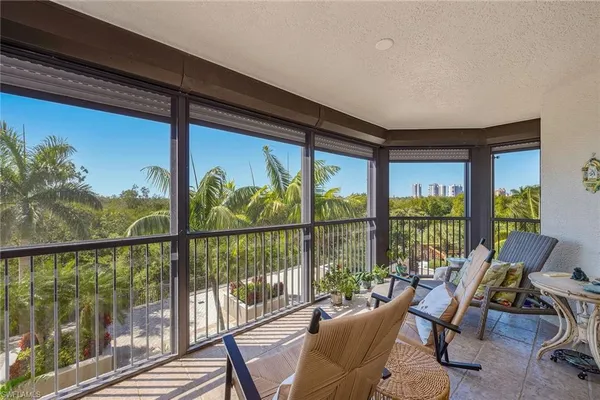 a view of a chairs and table in patio