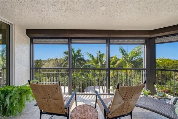 a view of a balcony with furniture