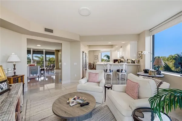 a living room with furniture and a floor to ceiling window