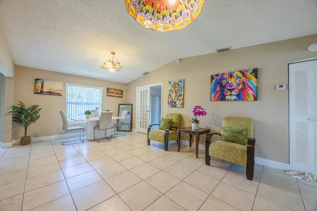 a living room with furniture and a potted plant
