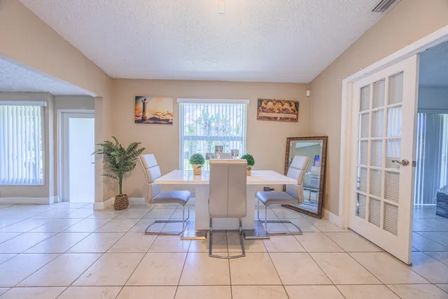 a living room with furniture a table and a potted plant