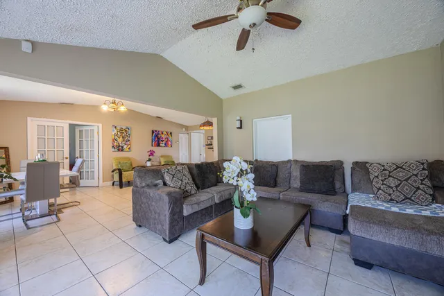 a bedroom with a bed window and dresser