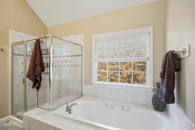 a bathroom with a tub and a shower