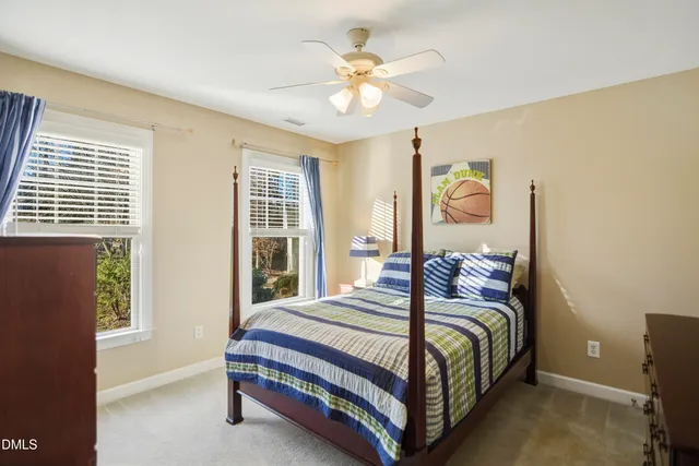 a bedroom with a bed and a large window with the outer view