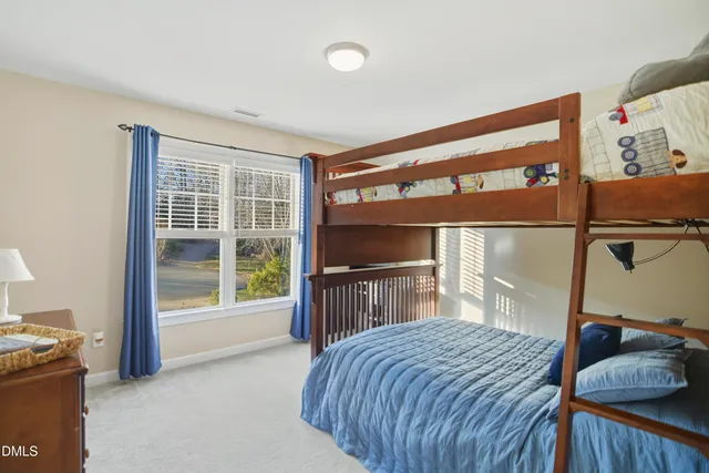 a bedroom with a bed and a large window with the outer view