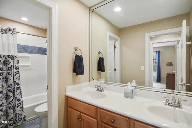 a bathroom with a double vanity sink mirror and shower