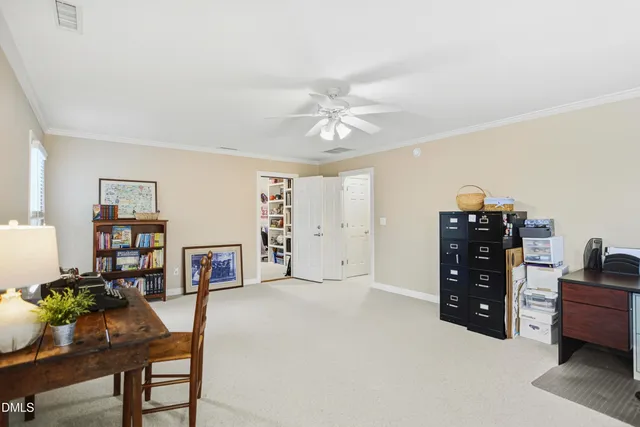 a view of a workspace with furniture and a window