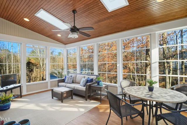 a living room with furniture and floor to ceiling windows