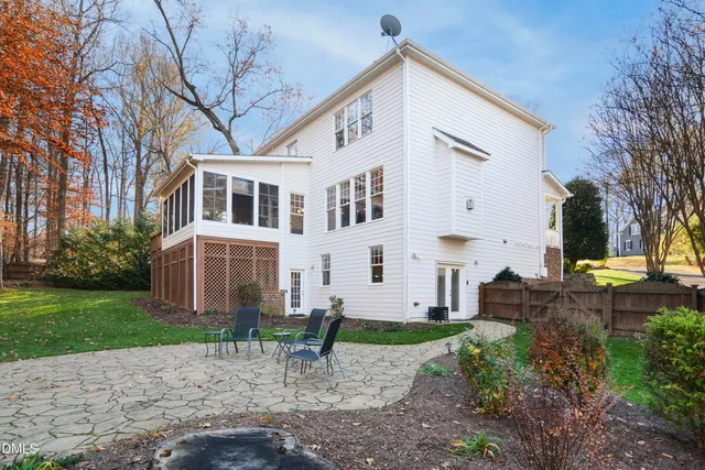 a front view of a house with a yard and outdoor seating