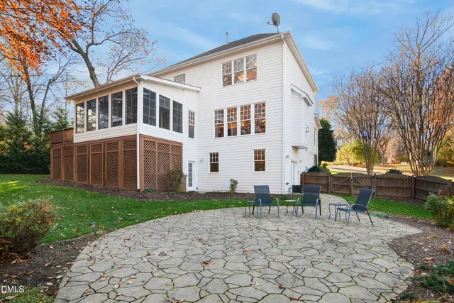 a view of a house with backyard and a tree