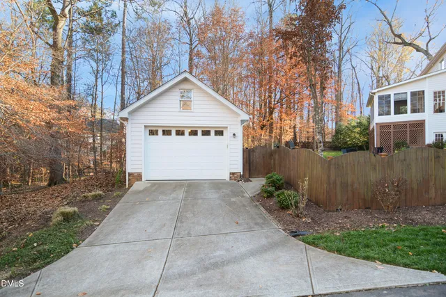 an aerial view of a house with swimming pool and outdoor seating