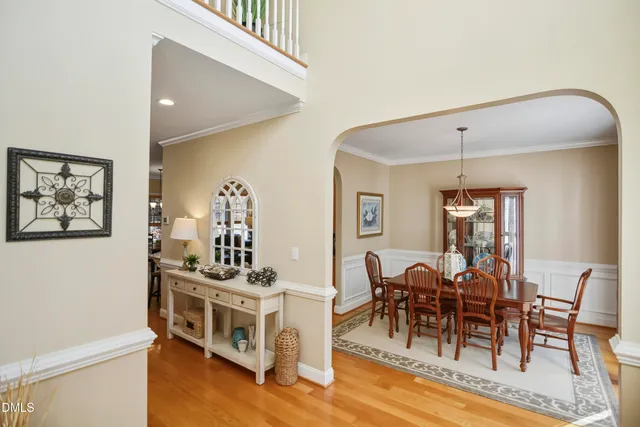 a view of a dining room with furniture and chandelier