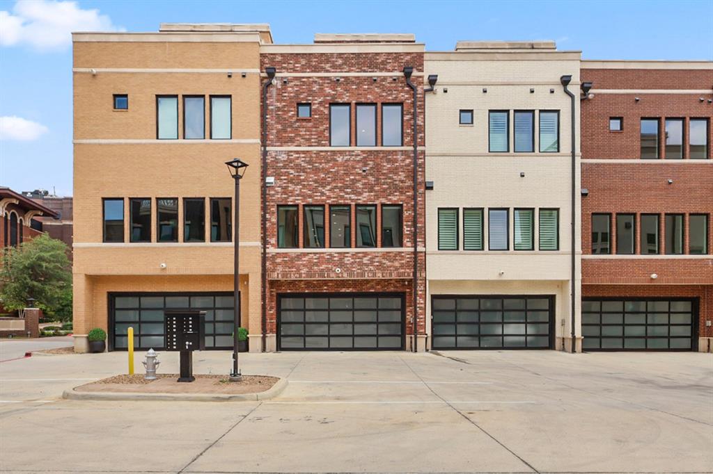 218 East Dallas Road, Unit 104 Grapevine, TX 76051 - Photo 39 of 40 Back of Brownstone Showcasing Garage + Parking