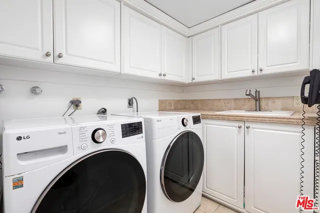 a utility room with sink dryer and washer
