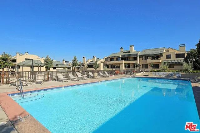 a view of a swimming pool with an outdoor seating