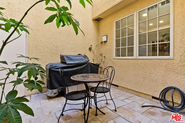 a table and chairs in a blue patio