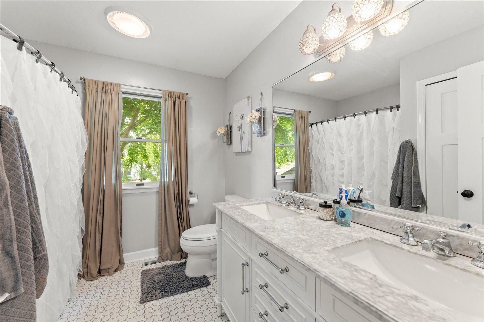 789 County Farm Road Monticello, IL 61856 - Photo 21 of 36 a bathroom with double vanity sink a mirror a toilet and a shower