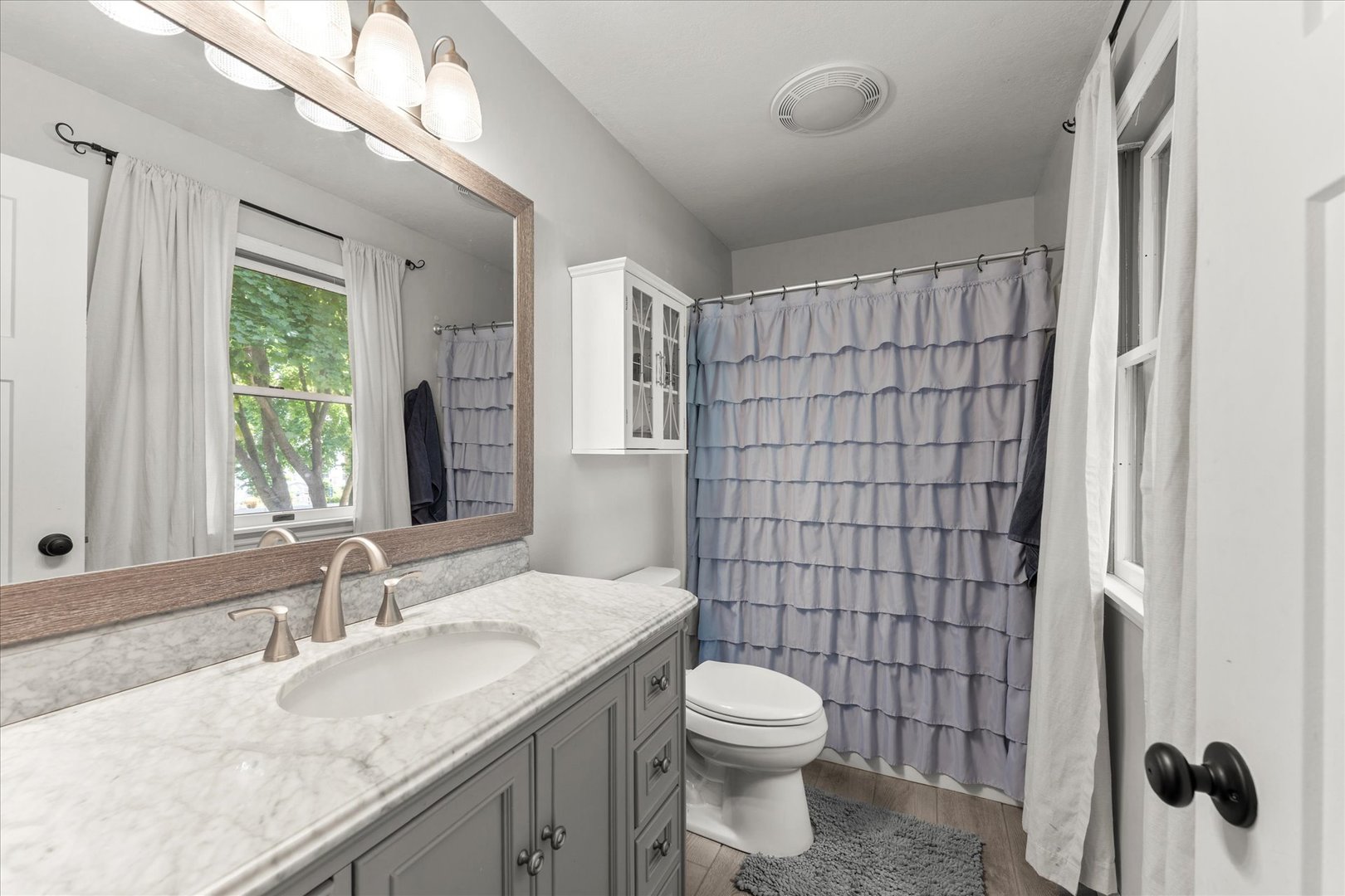 789 County Farm Road Monticello, IL 61856 - Photo 27 of 36 a bathroom with a granite countertop sink toilet and shower