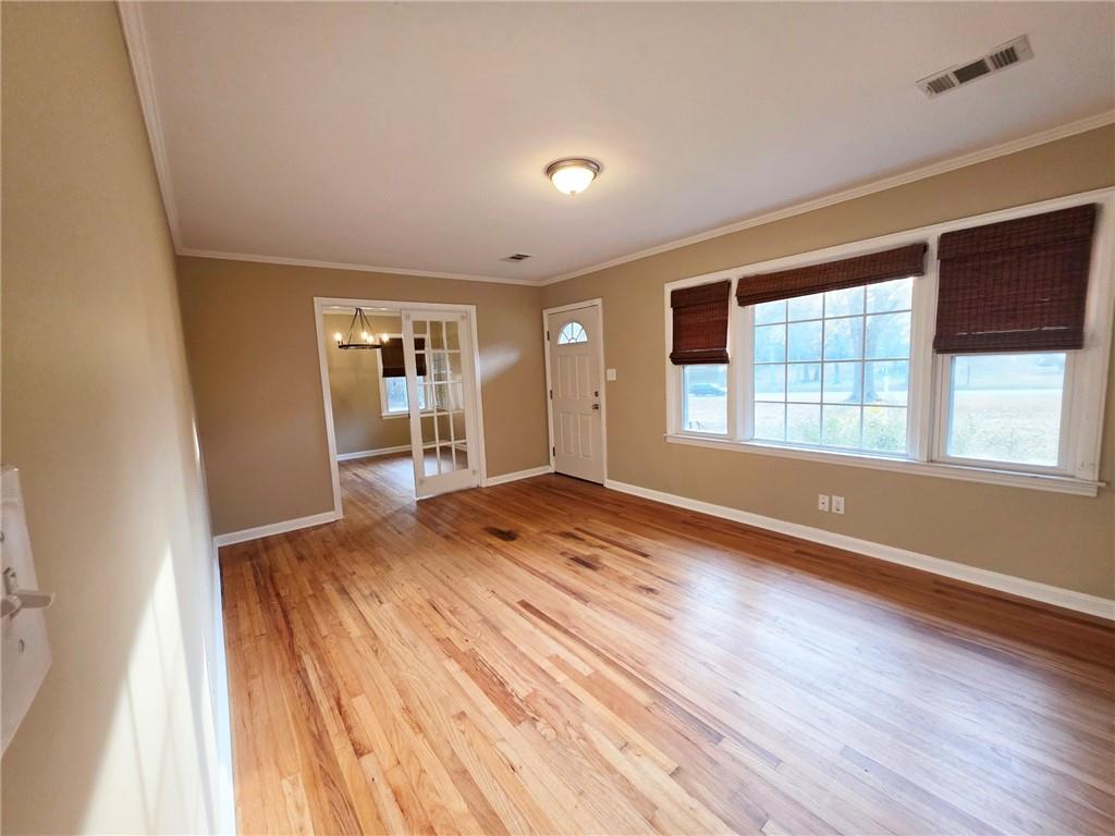 516 Monroe Highway Bethlehem, GA 30620 - Photo 5 of 10 a view of an empty room with wooden floor and a window