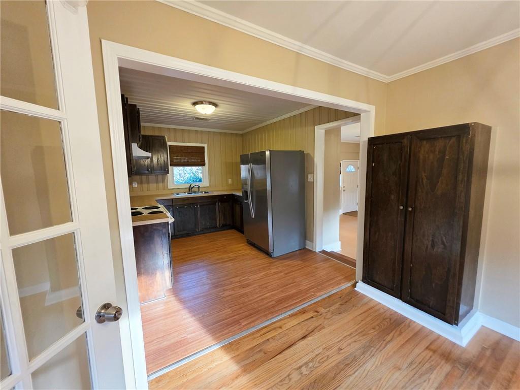 516 Monroe Highway Bethlehem, GA 30620 - Photo 7 of 10 a view of a kitchen with wooden floor and a refrigerator