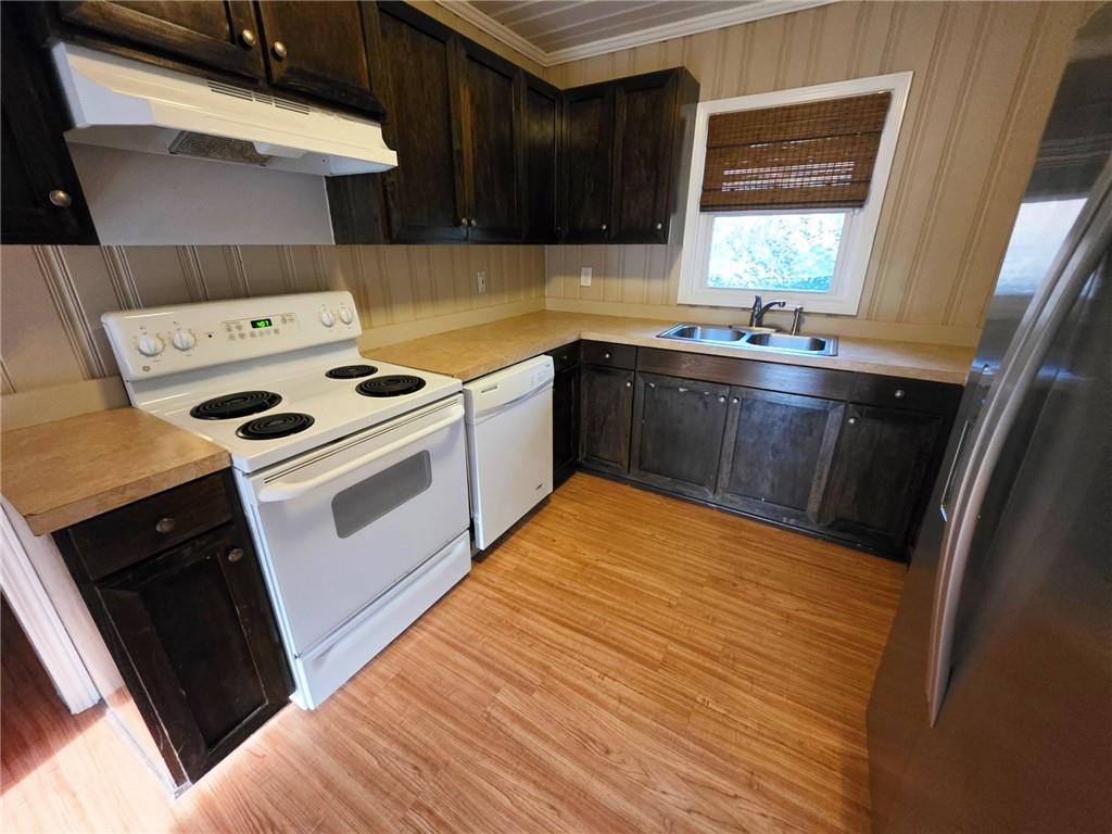 516 Monroe Highway Bethlehem, GA 30620 - Photo 8 of 10 a kitchen with a stove wooden floor and a sink