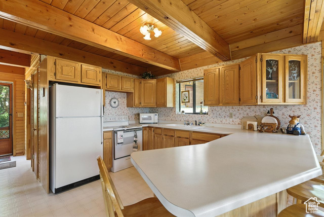 1180 Oak Road Coalville, UT 84017 - Photo 3 of 25 Kitchen featuring light floors, a peninsula, white appliances, glass insert cabinets, and light countertops