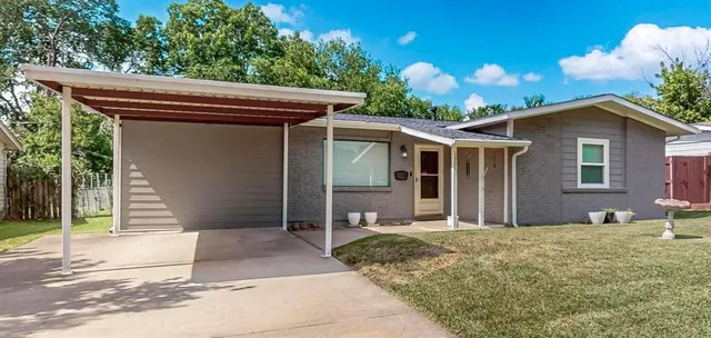 a backyard of a house with table and chairs