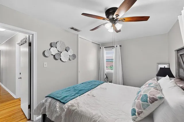 a bedroom with a bed and a chandelier