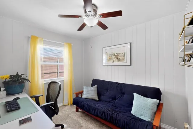 a living room with furniture ceiling fan and a window