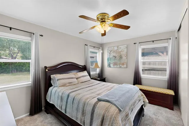 a bedroom with a large bed and a window