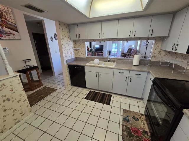 a kitchen with a sink and cabinets