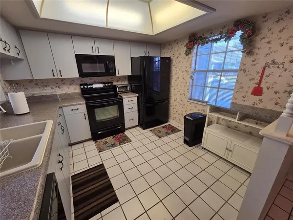 a kitchen with granite countertop a stove and a refrigerator