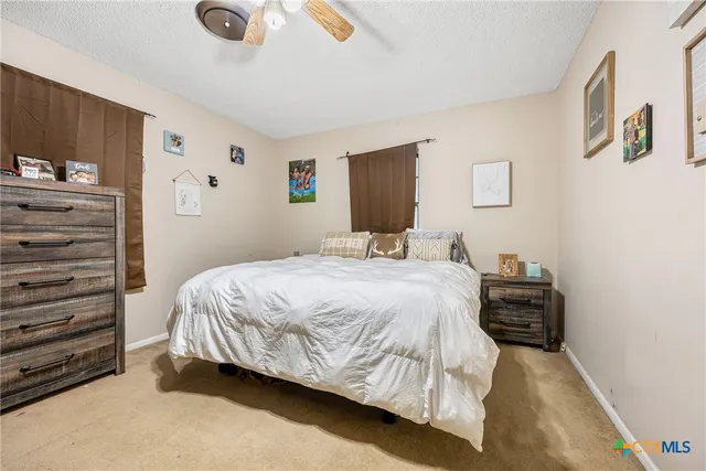 a bedroom with a bed and a table