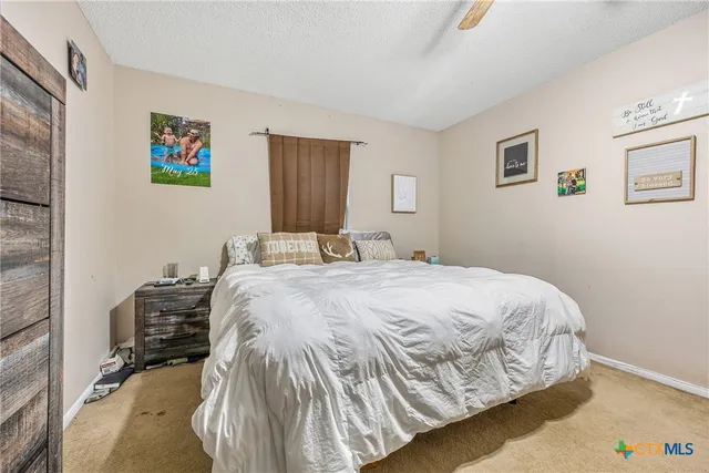 a bedroom with a bed and a baby bed