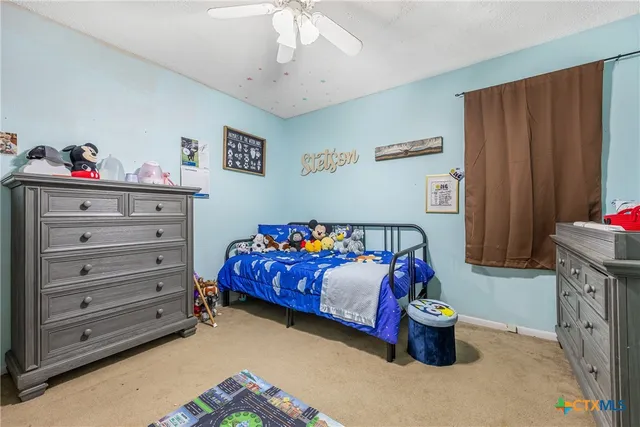 a utility room with wooden floor washer and dryer