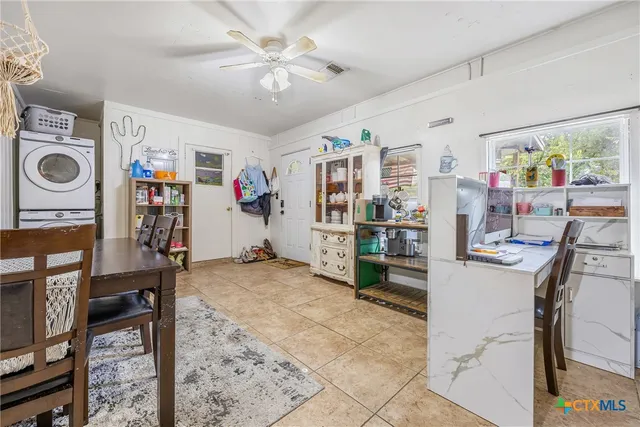 a view of a livingroom with furniture and a chandelier fan