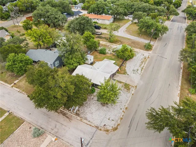 an aerial view of a house with a yard