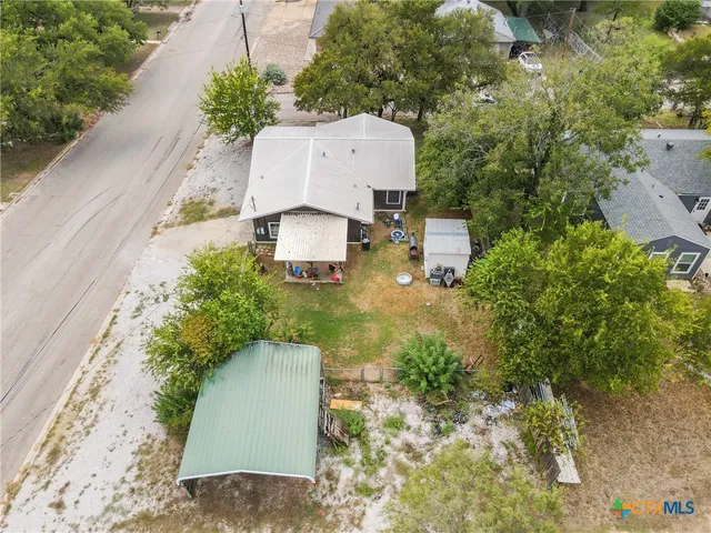 an aerial view of a house with a yard and garden