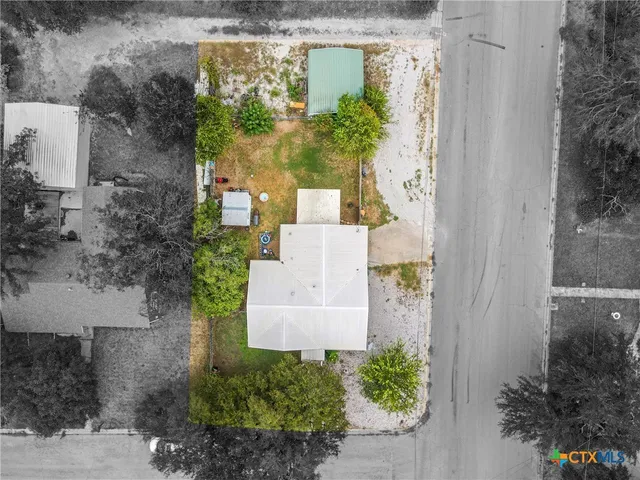 an aerial view of a house with outdoor space and street view