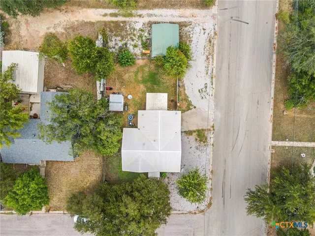 an aerial view of a house with a garden and a fountain