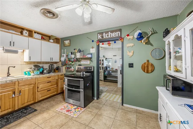 a kitchen with stainless steel appliances a stove a refrigerator and cabinets