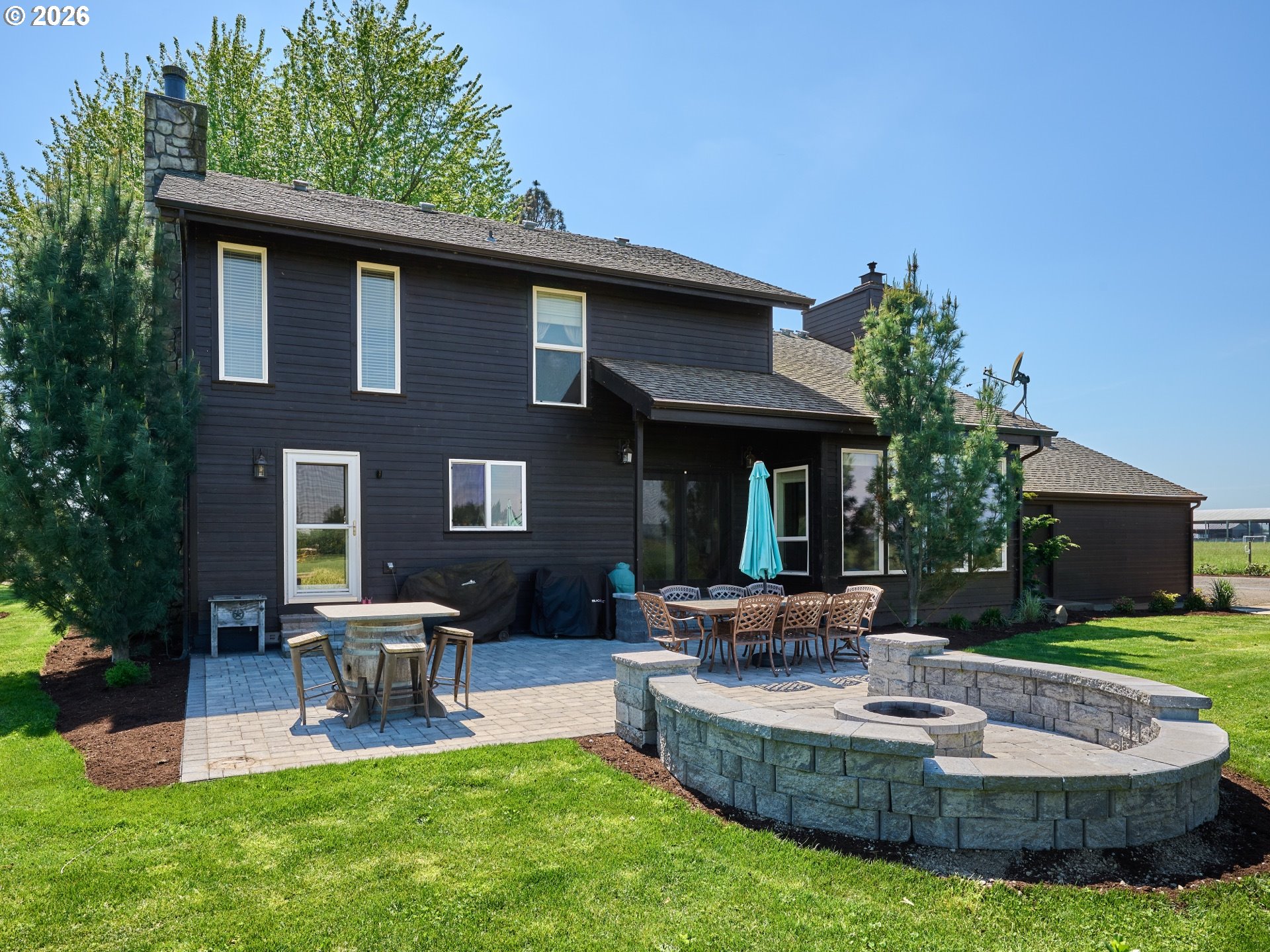 9293 Broadacres Road Northeast Aurora, OR 97002 - Photo 31 of 48 a view of a house with a yard patio and fire pit