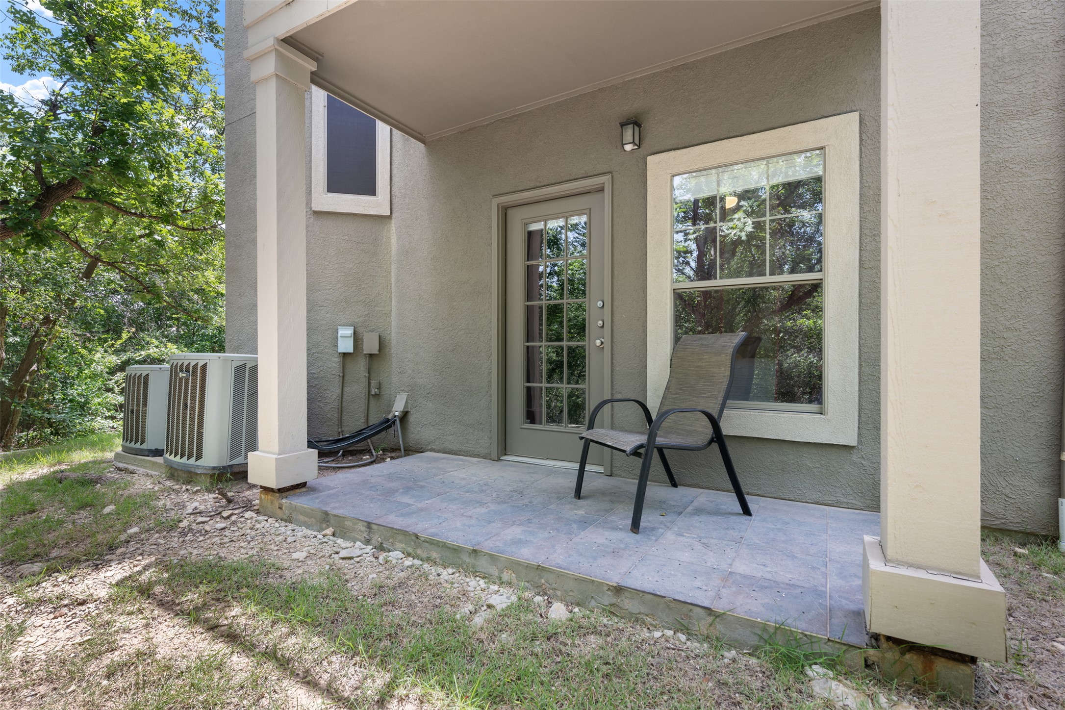 11203 Ranch Road 2222, Unit 1407 Austin, TX 78732 - Photo 15 of 40 The private patio off the entry level primary suite provides a private outdoor retreat space under the cover of the balcony above.