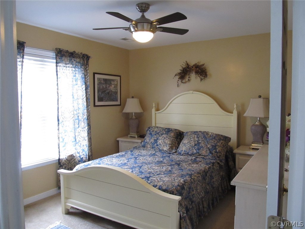 9366 Springmount Terrace Chesterfield, VA 23832 - Photo 14 of 20 a bedroom with a bed and a chandelier