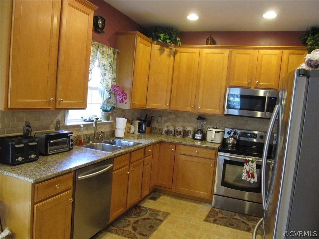 9366 Springmount Terrace Chesterfield, VA 23832 - Photo 3 of 20 a kitchen with stainless steel appliances a stove a sink a microwave and cabinets