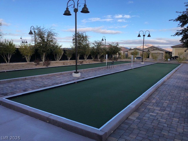498 Pebble Run Avenue Henderson, NV 89011 - Photo 44 of 47 This community bocce court, illuminated by classic streetlights, offers a lively outdoor recreational space.