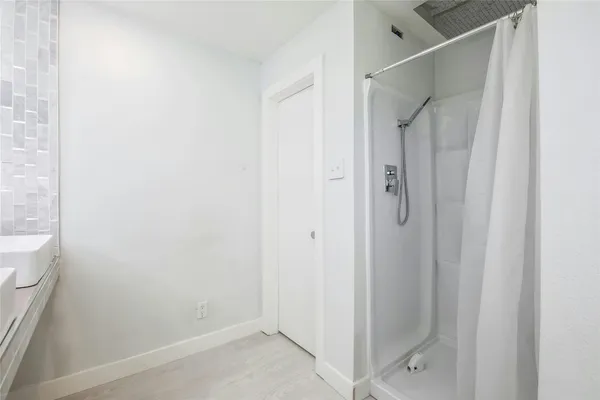 a bathroom with a glass shower door