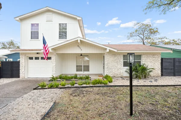a view of back yard with wooden fence