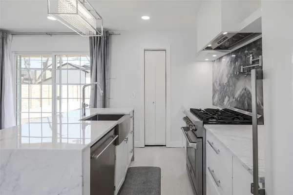 a kitchen with a stove and a sink
