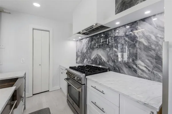a kitchen with a stove and a shower
